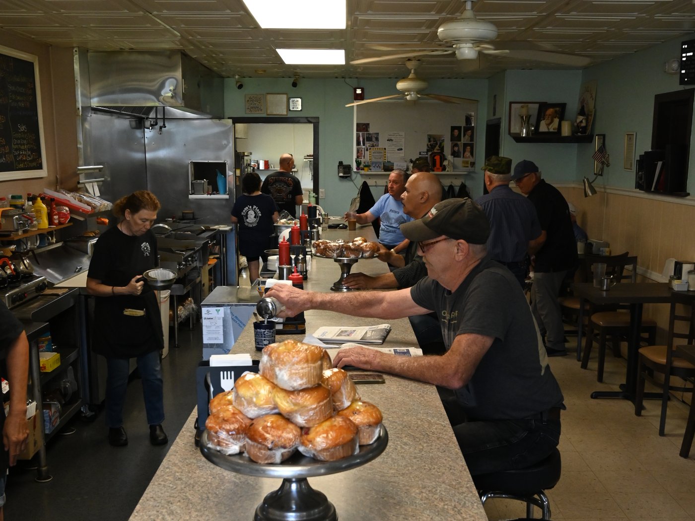 Muffins on the counter with the regulars and the morning paper